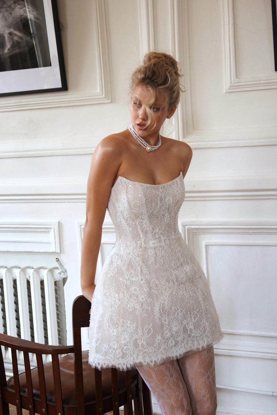 Short wedding dress with long detachable sleeves and a corset back and zipper. Main material: lace