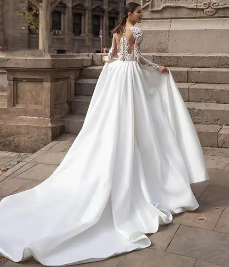 Boat neck long sleeves illusion back buttons embroidery lace A-line bridal gown 2026 – Pollyanna Events
