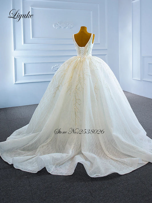 Liyuke Елегантний стиль спагетті ремінці з м'ячею сукню Весільна сукня приголомшливих аплікацій Мережива весільна спідниця