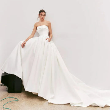 2025 Strapless Satin Wedding Dresses With Pockets Backless Bow Court Train Brides Gown Modern Simple Bridal Dress Customized