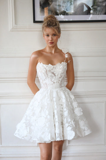 Short wedding dress with a full skirt and one strap. The back has a corset with lacing and a zipper. Main material: lace