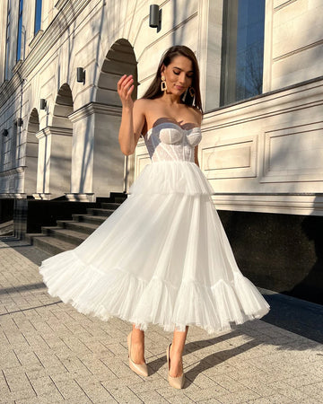 Elegant white midi dress with corset and lace